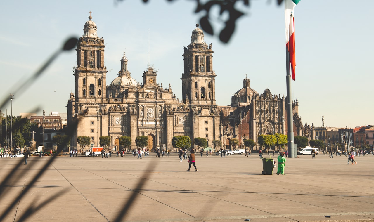 Mexico — people walking on sidewalk near brown concrete building during daytime